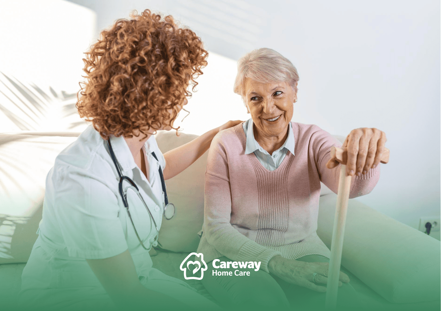 A professional home caregiver =talking to a senior holding a cane